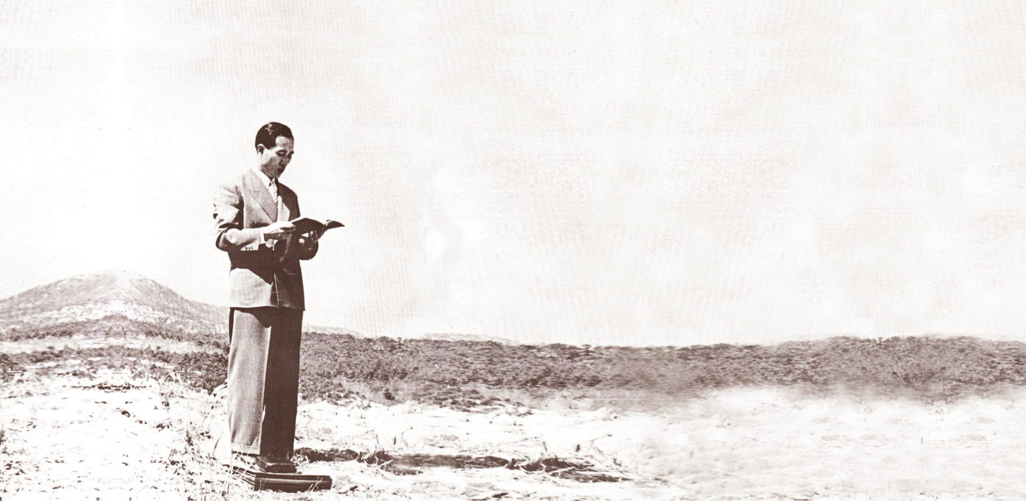Rev. Moon standing with a Bible